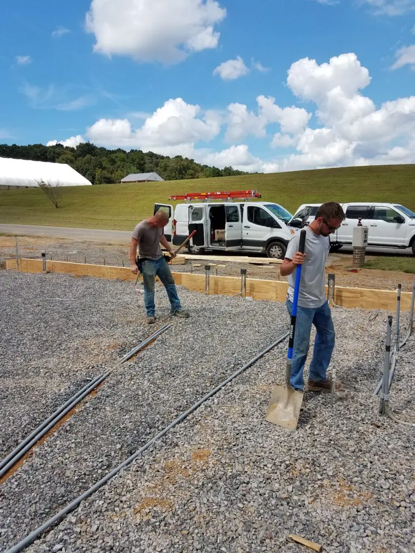 Electricians installing underground wiring